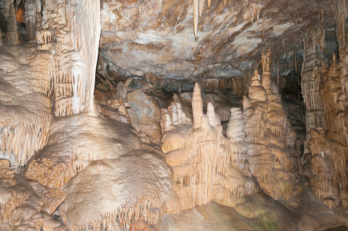 Beautiful rock formations within Lehman Caves, many from the floor to the ceiling of the cave, in cream, bronze, and light orange color variations.