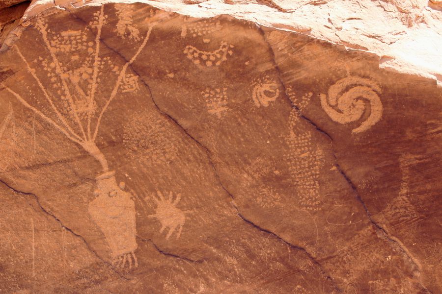 Detailed section of ancient rock art at Cub Creek in Utah’s Dinosaur National Monument, with carvings that appear to depict objects and animal-like shapes.