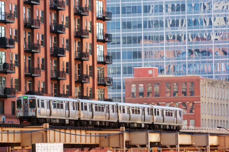 Elevated Chicago train passing through downtown, with skyscrapers in the background.