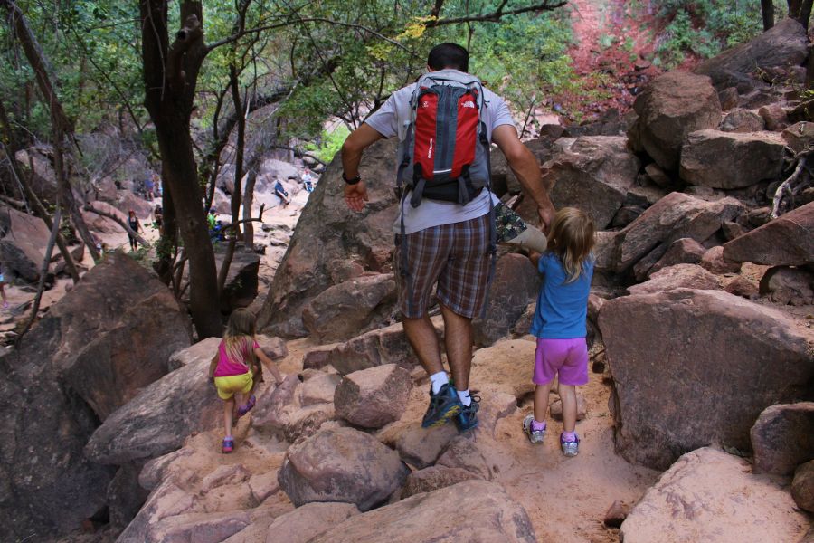 Family crossing a boulder-filled section just before reaching Upper Emerald Pool.