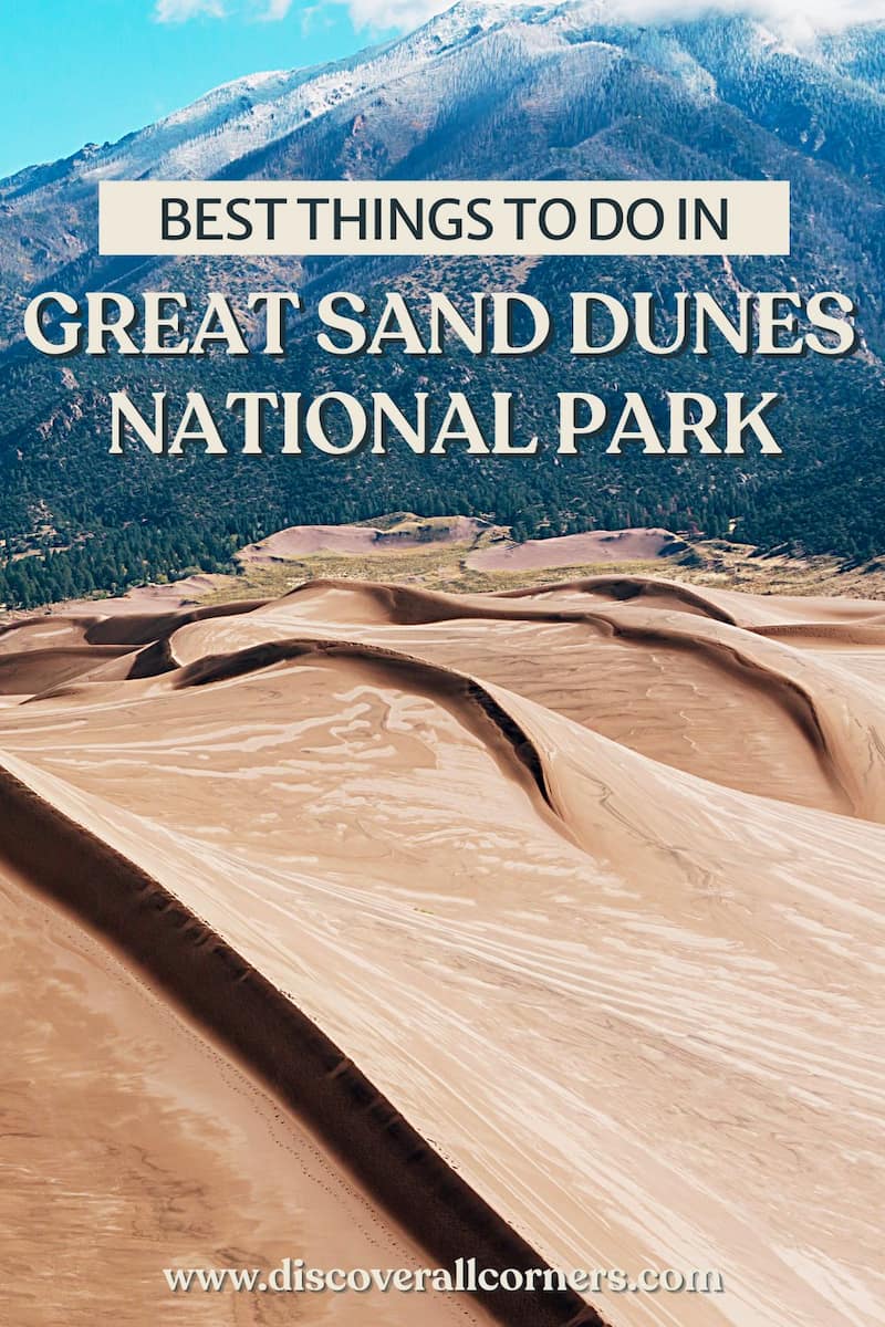 A wind-sculpted wide dunefield seen from above, with tall, forested mountains rising just behind. Text overlay - Best things to do in Great Sand Dunes National Park.