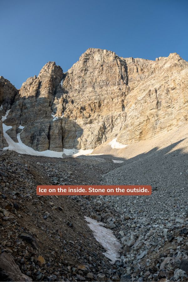 View of Wheeler Peak Glacier in Great Basin National Park showing rocky glacier terrain beneath steep alpine cliffs and lingering snow.