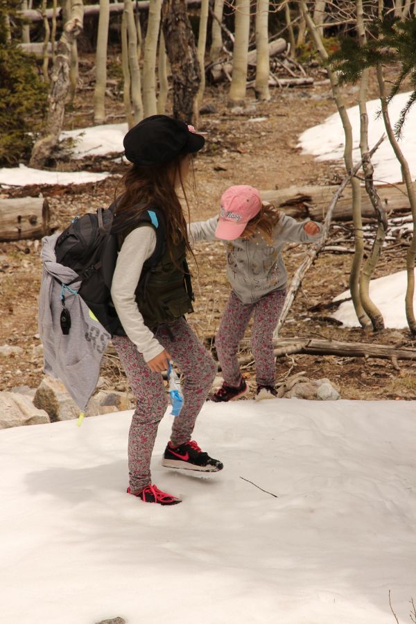 Children hiking through deep snow on the Lehman Creek Trail near Wheeler Peak.