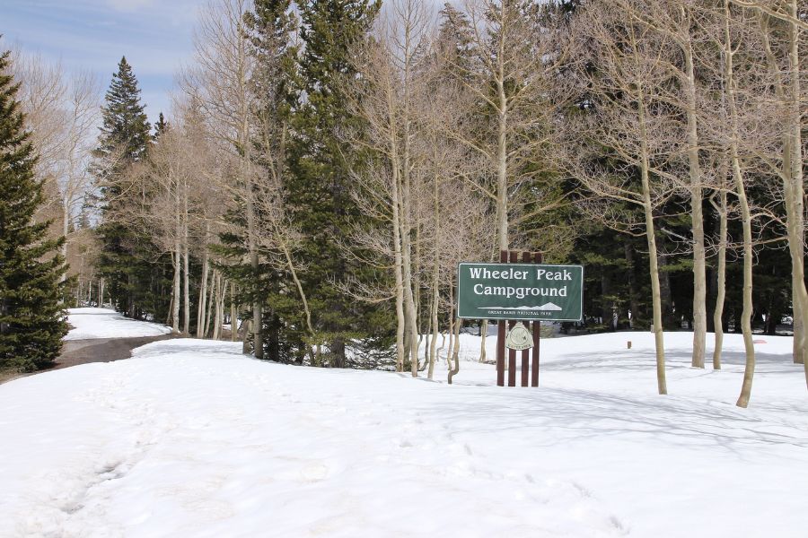 Large snowdrift surrounding the Wheeler Peak Campground sign in Great Basin National Park in early May.