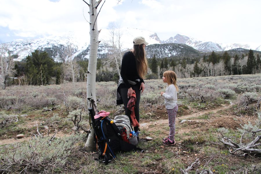 Mother and daughter standing beside a birch tree along the Lehman Creek Trail with Wheeler Peak and Doso Doyabi visible in the distance.